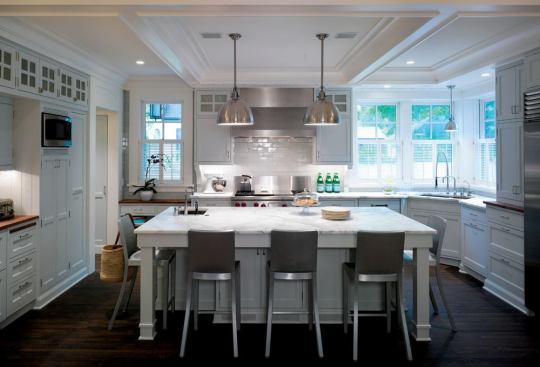 The simple color palette is a foil for the varied cabinetry.