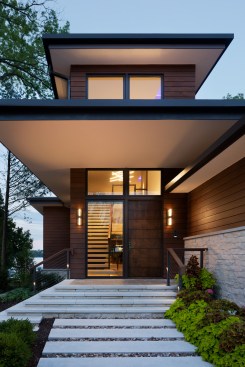 From the stone pavers and steps to the slicing planes of the dwelling, the eye is drawn in to the view of the floating stair and gathering spaces that expand through the house to the view of the lake.