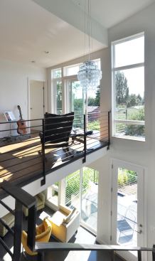 An open library on the second floor landing overlooks the expansive backyard gardens.