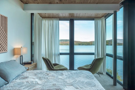 Floor-to-ceiling windows in the primary bedroom give some of the best views of the lake.