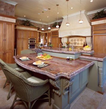 BIG ISLAND: The centerpiece of the home's amply appointed kitchen is a massive, multilevel island that encompasses eating, food prep, and storage while serving every other part of the space with its surface area.