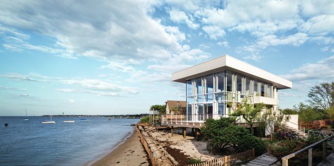 The north, east, and west façades are largely formed from double-height glazed walls that maximize daylight and views.