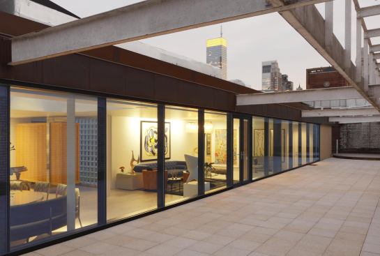 Sheltered by its buildingís historic parapet wall, this rooftop apartment includes a large, private outdoor space in the heart of Manhattan.