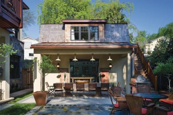 In this detached-garage-turned-entertainment-pavilion, one retractable cedar garage door provides a street entrance, while a second opens onto a pool patio with outdoor seating. Inside, the kitchen floor is the same herringbone brick as the driveway. 
Project: Rosedale Garage Suite, Bethesda, Md.; Architect: Studio Z Design, Bethesda, Md.; Builder: Georgetown Development Corp., Monrovia, Md.