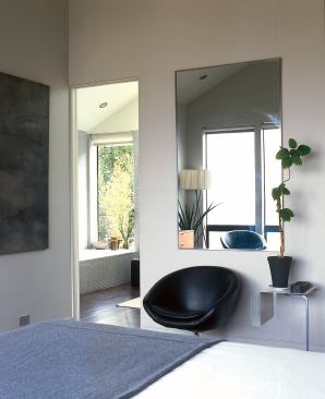 The master suite is a compact and efficient space, with the bedroom opening directly into the bath.