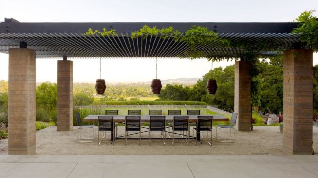 Composed of board-formed concrete columns, a gravel floor, and a repurposed pipe ceiling, this outdoor dining pavilion frames views of the Sonoma Valley foothills. 
Project: Sonoma Spa Retreat, Sonoma, Calif.; 
Architect: Aidlin Darling Design, San Francisco; 
Builder: Burlington Construction, Sonoma.