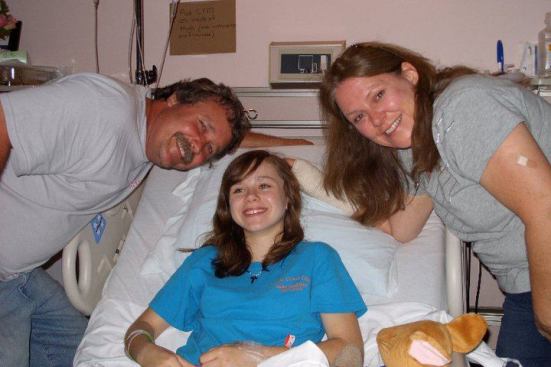 Kenny and Dianne Huddleston visit their daughter Emily at the hospital in Parsons, Kansas, where Emily was treated for a severe injury to one leg. Says Dianne: “She’s the strongest little girl I know.”
