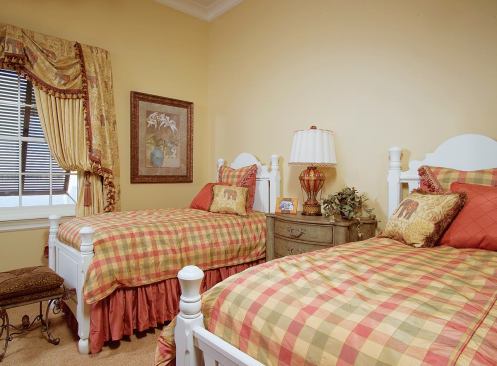 PAIRED OUT: The two bedrooms on the second floor mirror each other in size and features and share a bath, albeit with separate and pocket-door private vanity areas on either side of the tub/shower and toilet.