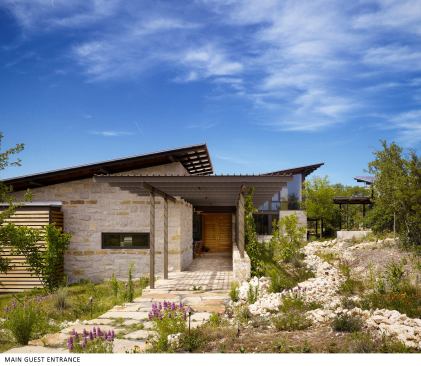 The low-lying, limestone-sided dwelling blends in with its rugged site. The clients wanted a home that used local, durable materials and efficient systems, had healthy indoor air quality, and allowed them to connect on a deeper level with nature.