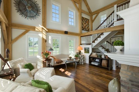 Exposed wood beams provide a rustic contrast to the white walls and millwork, but the simple forms don’t compete with the owners’ antiques.