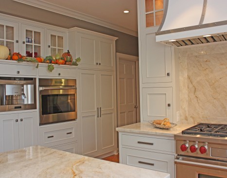 After shaking up the plan by moving walls, eliminating doors and enlarging the window, the new space was furnished with finely tailored cabinetry, quartzite tops and a custom built range hood as the focal point.