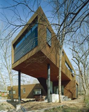 A view from the rear of the house, looking back toward the creek-spanning, one-story portion. 