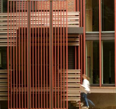 Almost solid wood member railings and vertical wood screen walls define outdoor rooms and provide varied levels of privacy from the park.