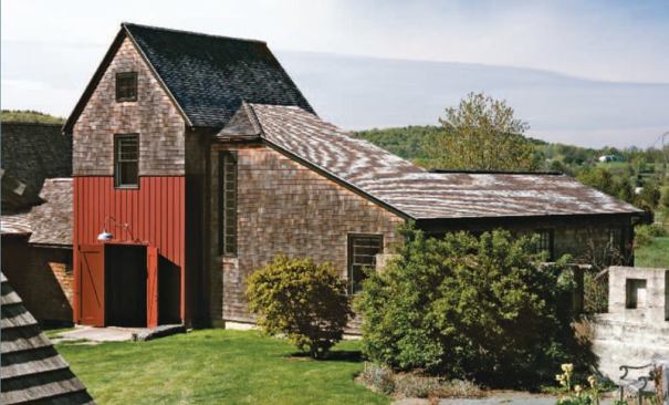 Barn detailing extends to the outside where red board and battens along with oversized swinging doors announce that this space is the point of entry.