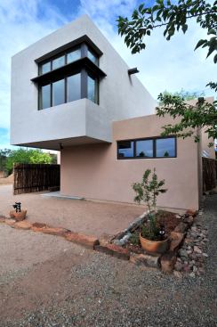 The house is on a very tight site, so rocks are used to define boundaries with the neighbors.