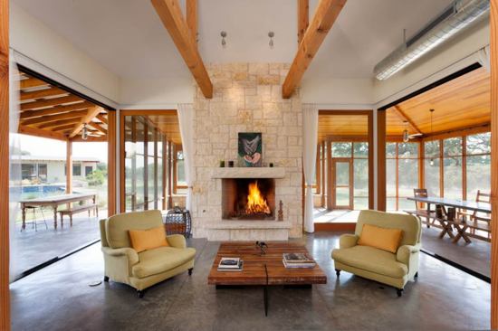 Broad, low pitched roofs shade the open-air living spaces that surround the living room.