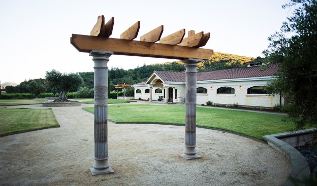 Photo by Dan Quinones, A redwood arbor sits at the front of the property for use in weddings and other celebrations.