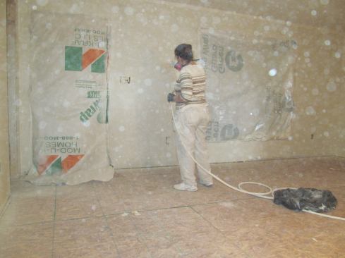 A worker spray-paints a module’s interior walls.