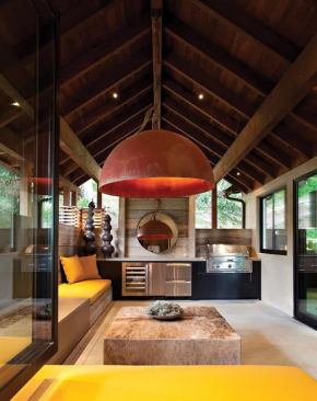 This shaded patio extends out from the main kitchen to offer additional seating, a grill, refrigerator drawers, and a wine cooler. Radiant-heated floors and a fireplace keep things cozy when the temperature drops. A light fixture--crafted from a recycled buoy cut in half - emphasizes the homeowners' commitment to recycling, sustainability, and reuse. 
Project: Hillside House, Mill Valley, Calif.; Architects: Scott and Tracey Lee, Mill Valley