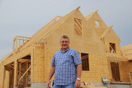 Joplin homebuilder Gary Rose in front of a new house under construction on South Wingate street in Joplin. Rose built 18 new homes in the year following the tornado.