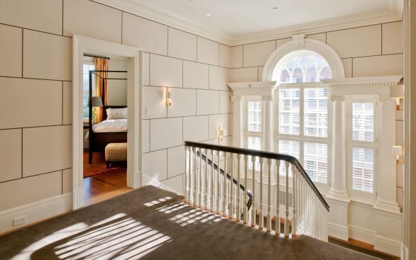 Little of the home's original interior trim survived, so the design team took their cues from the Neo-Classical exterior of the house. The wall treatment is leather panels, applied running board style.