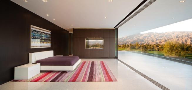 A wall of sliding doors opens this master bedroom to an expansive concrete roof deck.   2012 CHDA  Desert Panorama House, La Quinta, Calif.  Merit Award/Custom Home More Than 5,000 Square Feet  XTEN Architecture, Culver City, Calif.