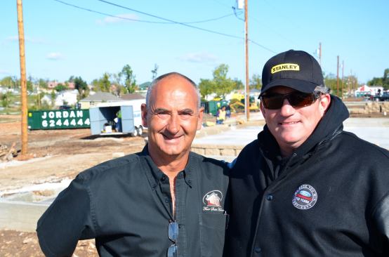 Builder Charlie Kuehn of Four State Homes in Joplin, an HBA board member, with Todd Parrott, Crew Chief No. 9 for NASCAR Driver Marcos Ambrose at the site of the seven-house, seven-day, Extreme Makeover build in Joplin after the tornado. Kuehn coordinated the efforts of seven HBA builders in the Extreme Makeover build. During the rebuilding, Kuehn played a key role in helping to organize out-of-town builders to perform insurance work, providing space in his own office for insurance adjusters to work, and guaranteeing the work of builders from nearby Springfield.