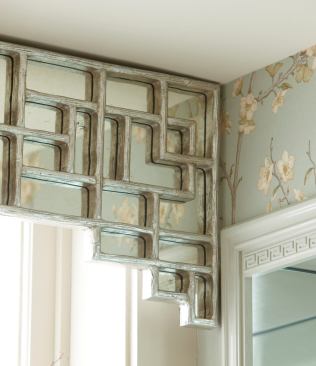 The Chinoiserie detailing on the tub valance and mirrors is wood painted with a metallic finish.