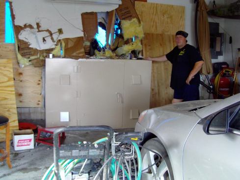 Twister Safe’s Jeremy Davis poses with a Twister Safe unit that survived the tornado, sheltering the owners as their house was destroyed in the storm. Jeremy Davis supervises construction and installation of the units in the family-run company.