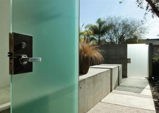 Matching translucent doors create a sense of privacy and transition between the street and this home, without being unwelcoming. Project: Private residence, Venice, Calif.; Architects: Abramson Teiger Architects