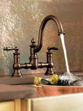 Lovely Vintage  Moen's Waterhill collection spans kitchen, bath, and bar so homeowners can feature the vintage look throughout the home. The bridge design and gooseneck spout available from the kitchen collection offer provincial elegance. Choose from a range of finishes, including oil-rubbed bronze (shown) for an antique look. 
Moen | 800.289.6636 | moen.com