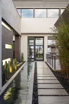 Thick stone pavers create pathways between areas of the home.