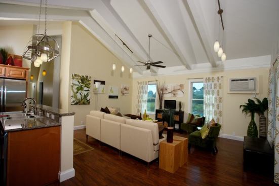 The completed interior features all the finishes of a traditional home—bamboo floors, high ceilings, and stainless steel appliances.