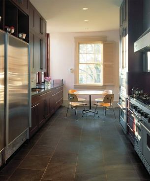 Original window frames and shutters in the remodeled kitchen help ease the transition between old and new sections of the house.