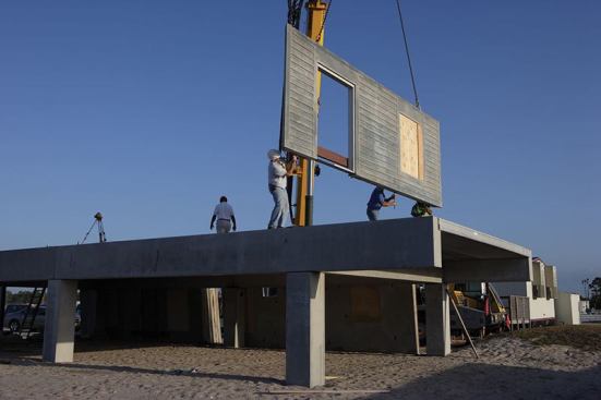 On site, the walls are erected and bolted together. Each is made from interior and exterior 3-inch concrete skins over a continuous 2-inch foam board.