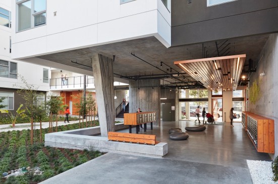 A covered open-air lobby on the ground floor of Five88 in San Francisco, designed by David Baker Architects, contains resident mailboxes and access to the central courtyard.