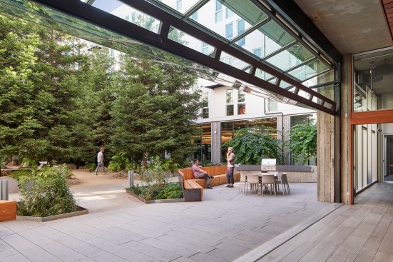 David Baker Architects creates indoor-outdoor connection with a grove of redwood trees at 855 Brannan in San Francisco.