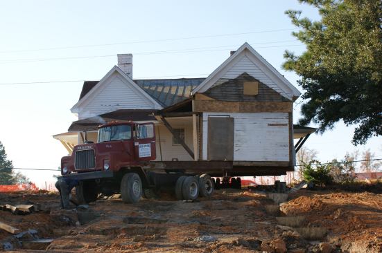 The farmhouse was moved about 40 feet; its former barns and outbuildings were repositioned as well to relatively match their former circle around the house.