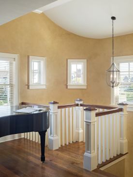 At the top of the stairs is a baby grand piano, a program requirement that was "sprung on me at the last minute," says Bubnowski. “I was 99 percent sure the piano would fit around the stair, but I still lay awake worrying."