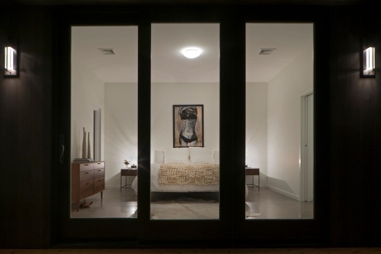 This view of the master bedroom from a partially enclosed portion of the deck demonstrates the intimacy of the private wings. 