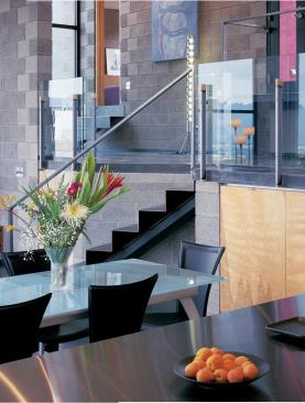 Horizontal windows ensure a sense of movement throughout the house. Interior and exterior walls both consist of exposed concrete masonry.