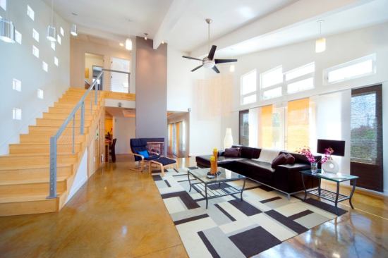 Heather’s Home is marked by high ceilings and light-filled interiors. The concrete floors contain fly ash.