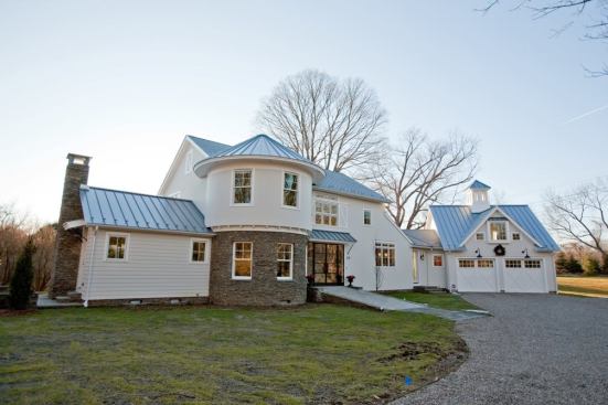 The house's design blends together elements from various New England barn typologies into a cohesive form that looks as if it were expanded over several generations. The ramp leading to the front entry is a common feature among barns, but also creates an accessible, step-free entrance.