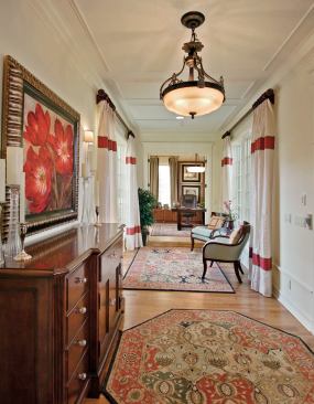 LAYERED EFFECT: You won't find a dramatic foyer unfolding into a two-story cathedral space here. The front door opens to a perpendicular gallery with a study at one end and a staircase at the other. Windows lining the gallery walls offer a beguiling peek into the courtyard that lies in the belly of the floor plan.