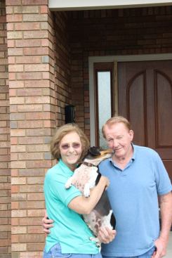 Eileen and Everett Wallace and dog Gus by the front door of their newly built house in Joplin. Says Everett, “We would go back to the way things used to be in a heartbeat.”