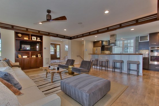 The first floor includes spacious living and dining spaces connected to the kitchen.