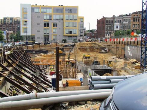 Crews and cranes are hard at work doing excavation and shoring work for UDR’s large 2400 14th Street project, a 255-unit apartment and mixed-use building. UDR, a public REIT, is the third owner in recent years of this property, the former home of the Nehemiah Shopping Center.