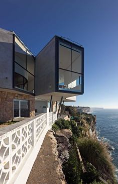 Raked cement stucco clads the house’s upper level.