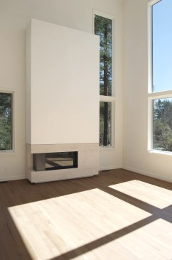 Living+room+fireplace+with+honed+Botticino+surround+and+spark+fire+gas+fireplace+is+detailed+to+float+above+the+quarter+sawn+red+oak+floors.+