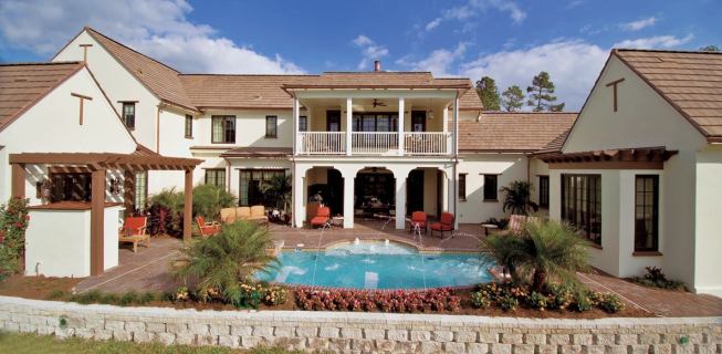 BIG HUG What's not to love about a floor plan that wraps its arms around the ultimate fresh air suite—complete with a hot tub that spills into a swimming pool, a sturdy grill kitchen, outdoor dining area, and an open air fireplace under an intimate pergola? Being at home is like being on vacation.